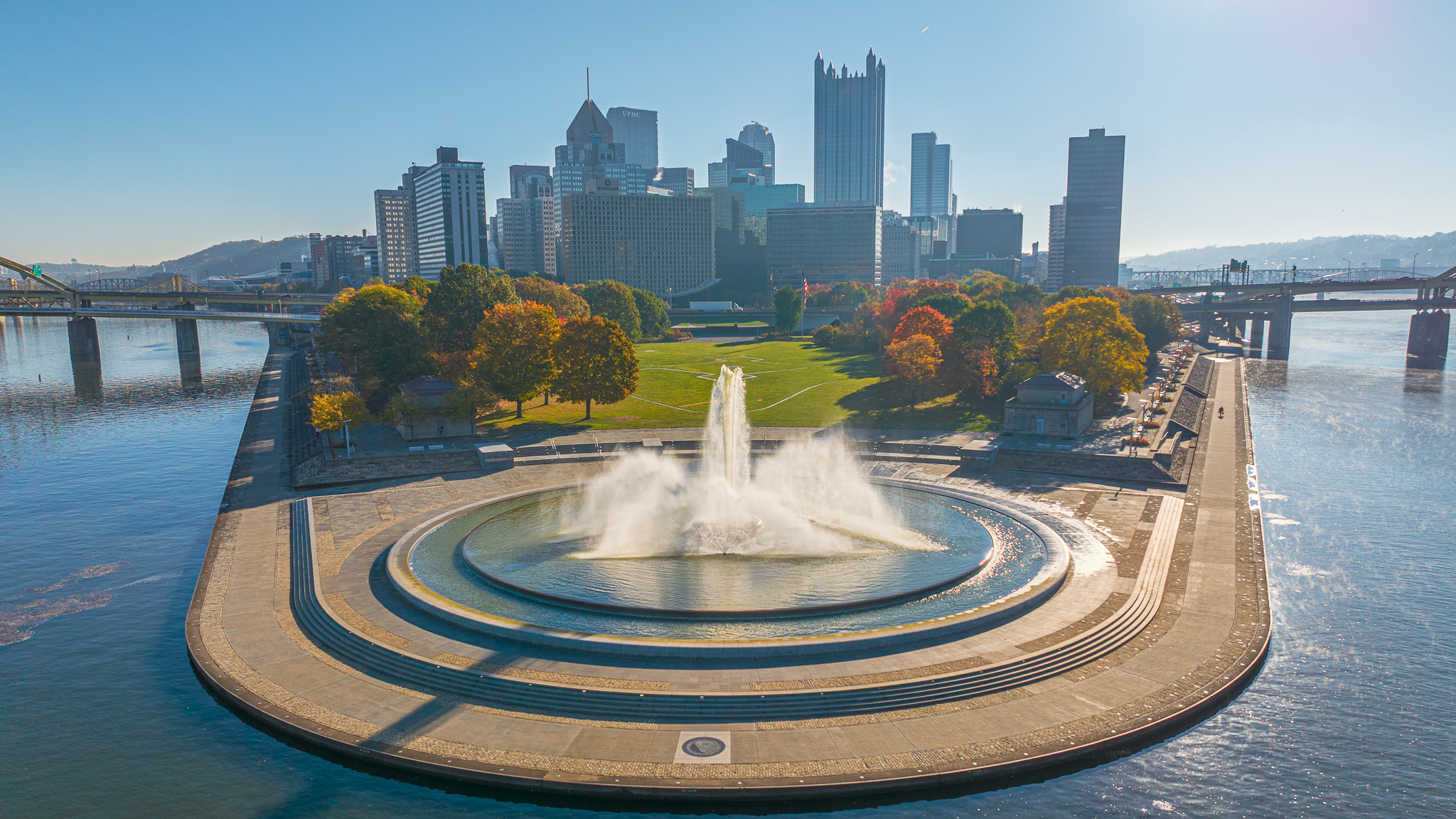 Close aerial view of Point State Park fountain with fall foliage